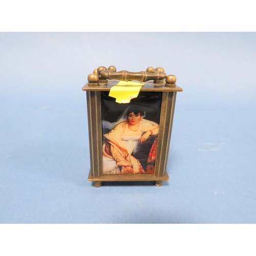 230 - A MODERN MINIATURE CARRIAGE CLOCK WITH PLASTIC PANELS DEPICTING NUDE FEMALE IMAGES