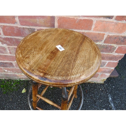 604 - AN INDUSTRIAL STYLE WOOD AND CAST STOOL