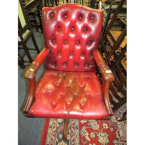 693 - AN OXBLOOD RED SWIVEL OFFICE CHAIR A/F