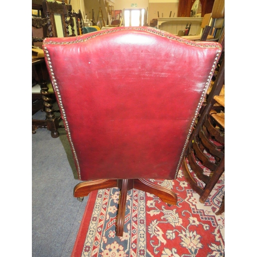 693 - AN OXBLOOD RED SWIVEL OFFICE CHAIR A/F