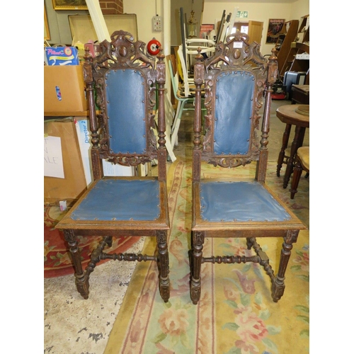 711 - A PAIR OF CARVED OAK JACOBEAN STYLE CHAIRS