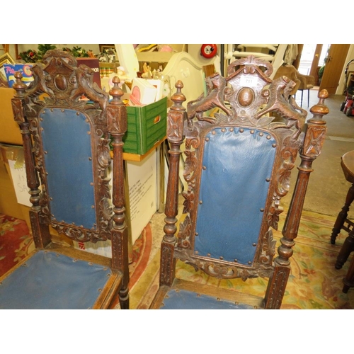 711 - A PAIR OF CARVED OAK JACOBEAN STYLE CHAIRS