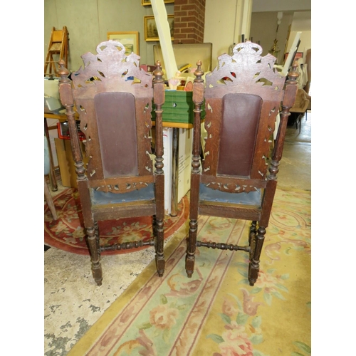 711 - A PAIR OF CARVED OAK JACOBEAN STYLE CHAIRS