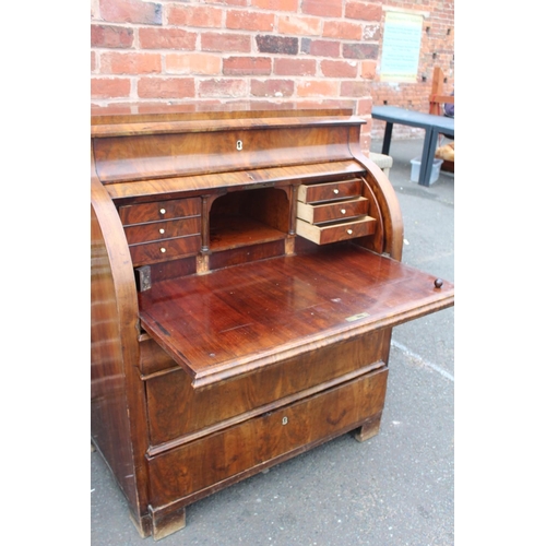 605 - A 19TH CENTURY BIEDERMEIER STYLE MAHOGANY CYLINDER BUREAU HAVING A FITTED INTERIOR,  the pull-out wr... 