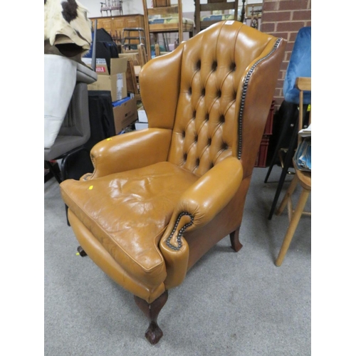 655 - AN ANTIQUE STYLE BROWN LEATHER WINGBACK ARMCHAIR