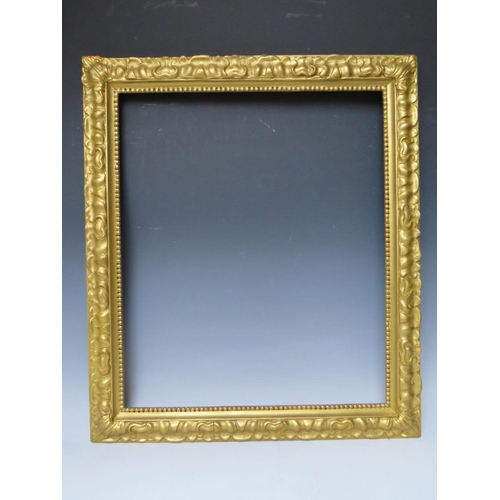 102 - A LATE 19TH / EARLY 20TH CENTURY DECORATIVE GOLD FRAME, with bead design to inner edge and plant des... 