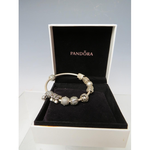 244 - A PANDORA CHARM BRACELET WITH ATTACHED CHARMS, together with a collection of empty Pandora boxes (8 ... 