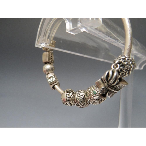 244 - A PANDORA CHARM BRACELET WITH ATTACHED CHARMS, together with a collection of empty Pandora boxes (8 ... 