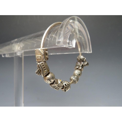 244 - A PANDORA CHARM BRACELET WITH ATTACHED CHARMS, together with a collection of empty Pandora boxes (8 ... 