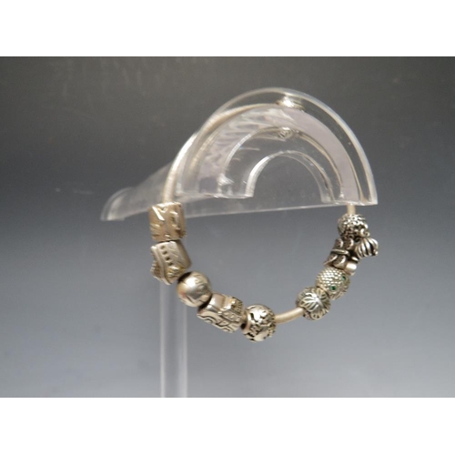 244 - A PANDORA CHARM BRACELET WITH ATTACHED CHARMS, together with a collection of empty Pandora boxes (8 ... 