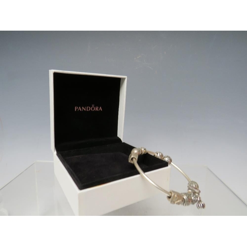 244 - A PANDORA CHARM BRACELET WITH ATTACHED CHARMS, together with a collection of empty Pandora boxes (8 ... 