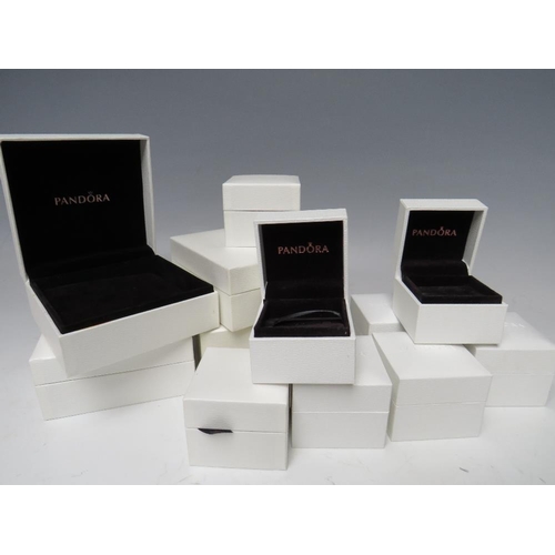 244 - A PANDORA CHARM BRACELET WITH ATTACHED CHARMS, together with a collection of empty Pandora boxes (8 ... 