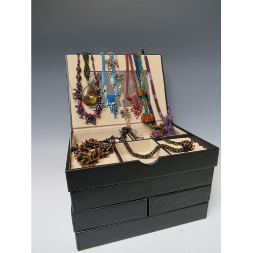 245 - A STACKING JEWELLERY BOX AND CONTENTS, comprising of approximately 40 handcrafted bead necklaces, ba... 
