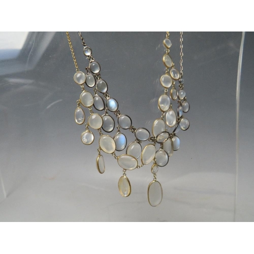 275 - A WHITE METAL AND MOONSTONE TYPE 'DROPPER' NECKLACE, together with a similar gold tone example (2)