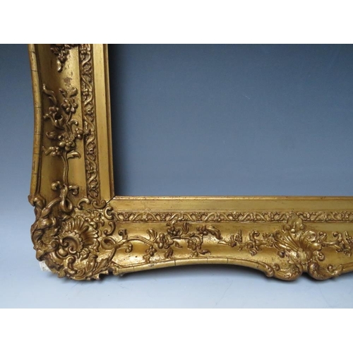 51 - A 19TH CENTURY DECORATIVE GOLD SWEPT FRAME, frame W 9 cm, rebate 62 x 51 cm