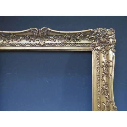 51 - A 19TH CENTURY DECORATIVE GOLD SWEPT FRAME, frame W 9 cm, rebate 62 x 51 cm