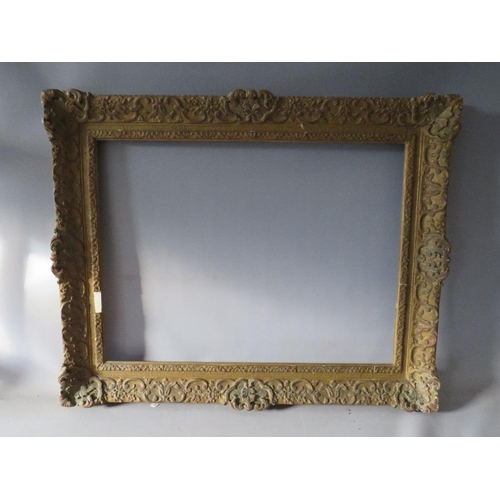 66 - A LATE 19TH / EARLY 20TH CENTURY DECORATIVE SWEPT GOLD FRAME, frame W 9 cm, rebate 62 x 47 cm