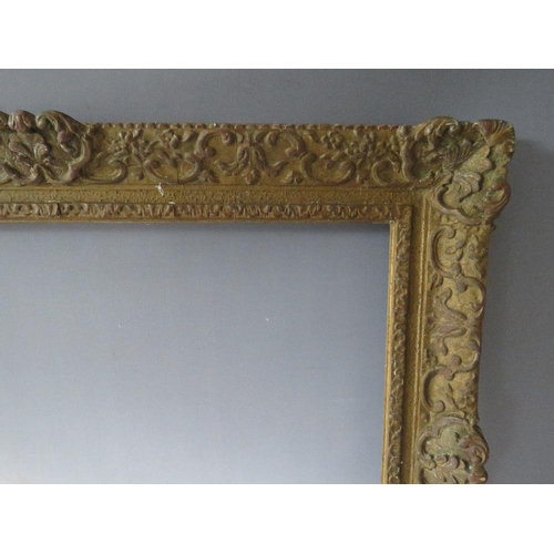 66 - A LATE 19TH / EARLY 20TH CENTURY DECORATIVE SWEPT GOLD FRAME, frame W 9 cm, rebate 62 x 47 cm