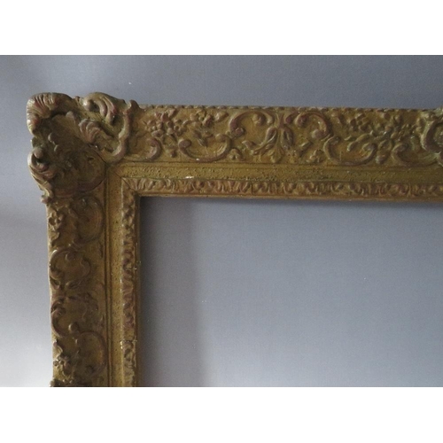 66 - A LATE 19TH / EARLY 20TH CENTURY DECORATIVE SWEPT GOLD FRAME, frame W 9 cm, rebate 62 x 47 cm