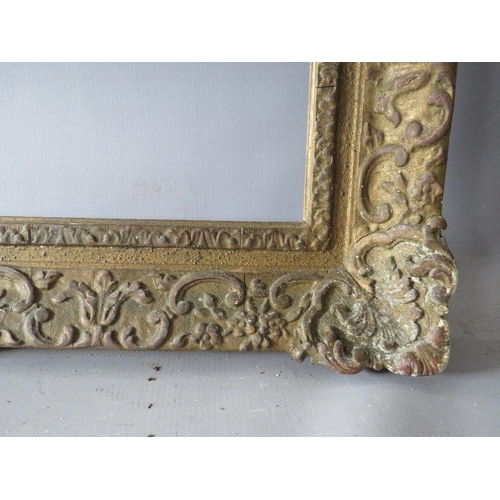 66 - A LATE 19TH / EARLY 20TH CENTURY DECORATIVE SWEPT GOLD FRAME, frame W 9 cm, rebate 62 x 47 cm