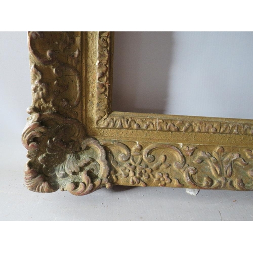 66 - A LATE 19TH / EARLY 20TH CENTURY DECORATIVE SWEPT GOLD FRAME, frame W 9 cm, rebate 62 x 47 cm