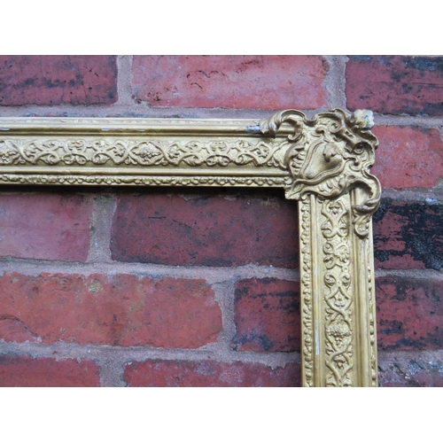 53 - A 19TH CENTURY DECORATIVE GOLD FRAME WITH CORNER EMBELLISHMENTS, frame W 7.5 cm, rebate 40 x 30 cm