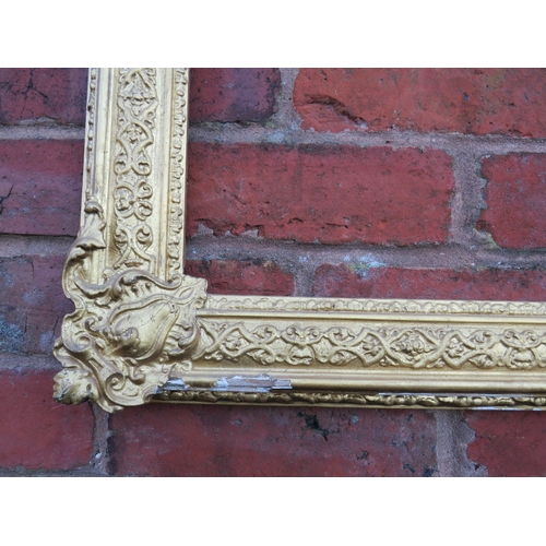 53 - A 19TH CENTURY DECORATIVE GOLD FRAME WITH CORNER EMBELLISHMENTS, frame W 7.5 cm, rebate 40 x 30 cm