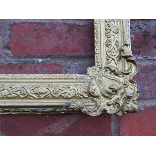 53 - A 19TH CENTURY DECORATIVE GOLD FRAME WITH CORNER EMBELLISHMENTS, frame W 7.5 cm, rebate 40 x 30 cm