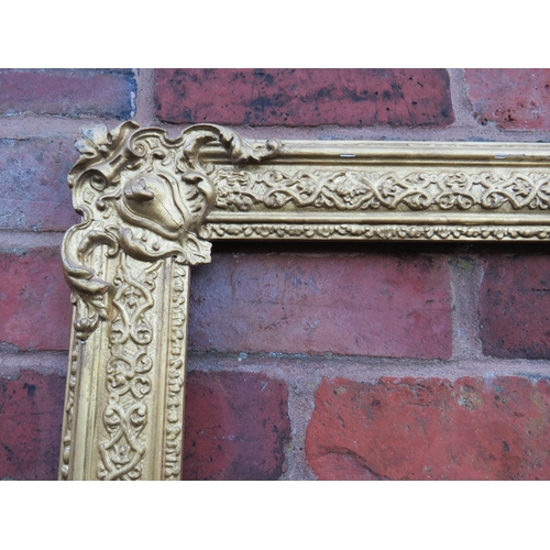 53 - A 19TH CENTURY DECORATIVE GOLD FRAME WITH CORNER EMBELLISHMENTS, frame W 7.5 cm, rebate 40 x 30 cm