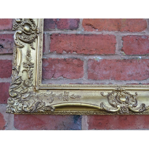 56 - A 19TH CENTURY DECORATIVE GOLD SWEPT FRAME, frame W 10 cm, rebate 54 x 36 cm