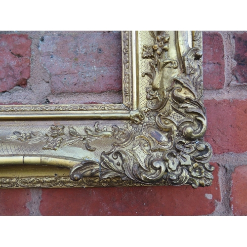 56 - A 19TH CENTURY DECORATIVE GOLD SWEPT FRAME, frame W 10 cm, rebate 54 x 36 cm