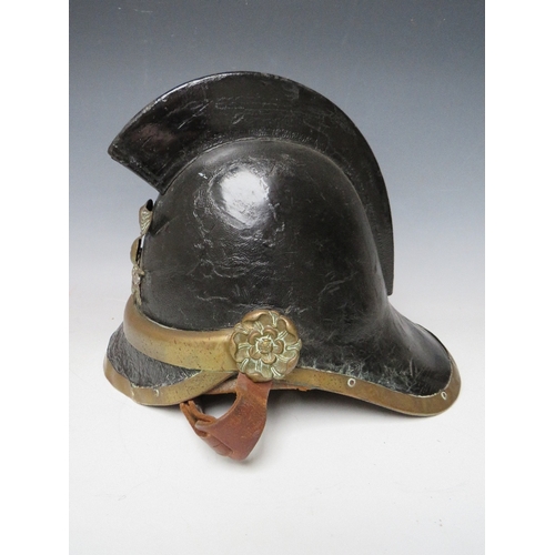 300 - A VICTORIAN MERRYWEATHER LEATHER FIREMANS HELMET, with brass banding and head badge