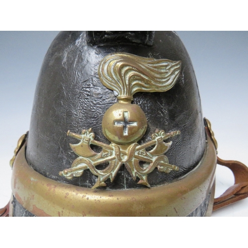 300 - A VICTORIAN MERRYWEATHER LEATHER FIREMANS HELMET, with brass banding and head badge