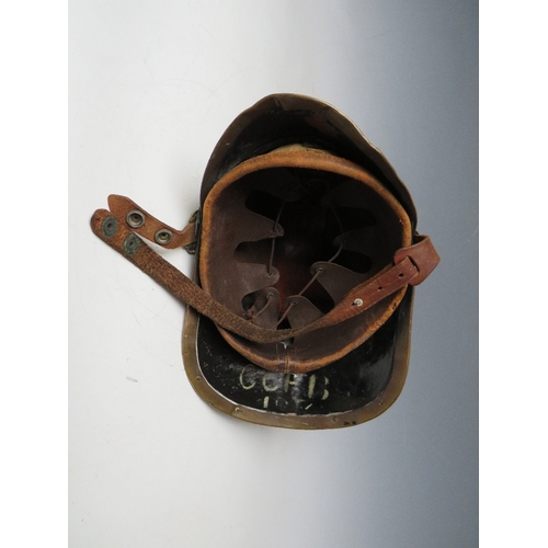 300 - A VICTORIAN MERRYWEATHER LEATHER FIREMANS HELMET, with brass banding and head badge