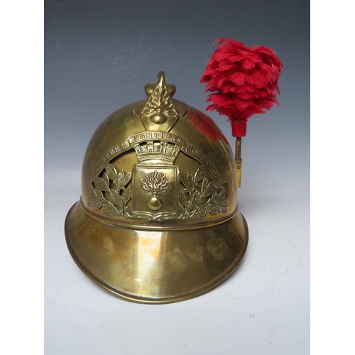 301 - A 19TH CENTURY FRENCH BRASS FIREMANS HELMET, with Sapeurs Pompiere Montrevil badge and side plume