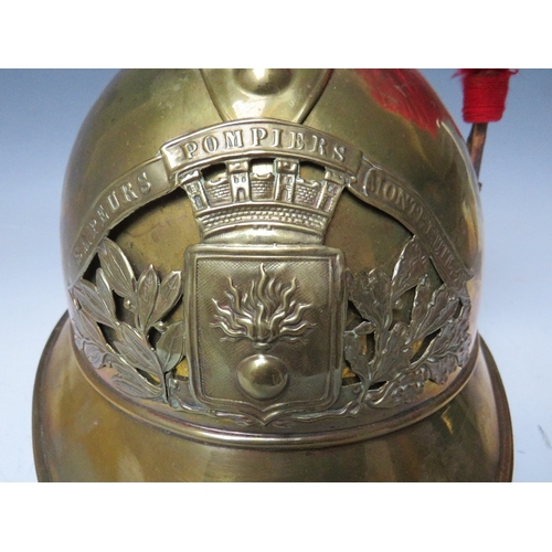 301 - A 19TH CENTURY FRENCH BRASS FIREMANS HELMET, with Sapeurs Pompiere Montrevil badge and side plume