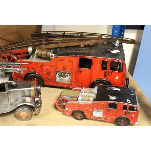 186 - TWO TIN PLATE FIRE ENGINES, a metal fire engine and two fire engine money boxes