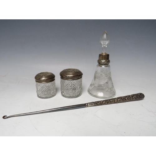 200 - A SILVER COLLARED PERFUME/ VANITY BOTTLE, together with two silver topped vanity jars and an ornate ... 