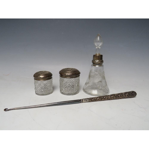 200 - A SILVER COLLARED PERFUME/ VANITY BOTTLE, together with two silver topped vanity jars and an ornate ... 