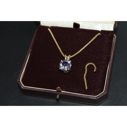 297 - A HALLMARKED 9 CARAT GOLD PENDANT ON SHORT CHAIN, with additional length of chain in box, set with a... 