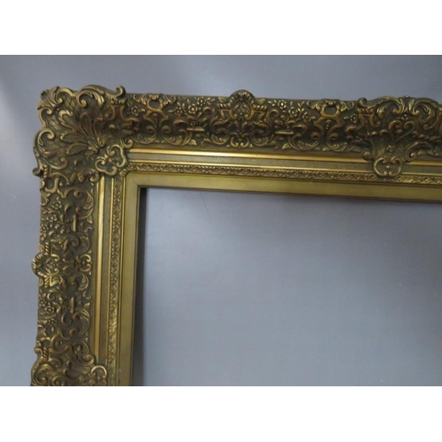 30 - A 19TH CENTURY DECORATIVE GOLD FRAME WITH GOLD SLIP, frame W 12 cm, slip rebate 77 x 64 cm, frame re... 