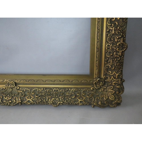 30 - A 19TH CENTURY DECORATIVE GOLD FRAME WITH GOLD SLIP, frame W 12 cm, slip rebate 77 x 64 cm, frame re... 