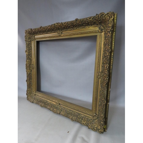 30 - A 19TH CENTURY DECORATIVE GOLD FRAME WITH GOLD SLIP, frame W 12 cm, slip rebate 77 x 64 cm, frame re... 