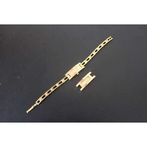 327 - A LADIES RECTANGULAR GOLD EFFECT GUCCI WRIST WATCH, together with spare movement housing, W 1.25 cm