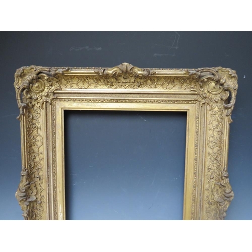 34 - A LATE 18TH / EARLY 19TH CENTURY DECORATIVE GOLD SWEPT FRAME, with integral slip, frame W 11 cm, reb... 