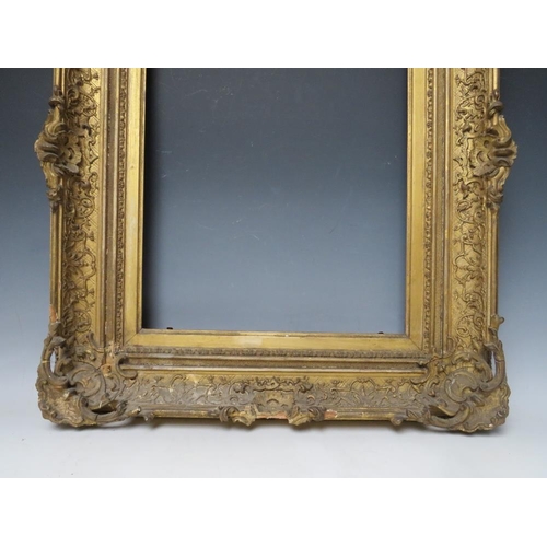 34 - A LATE 18TH / EARLY 19TH CENTURY DECORATIVE GOLD SWEPT FRAME, with integral slip, frame W 11 cm, reb... 