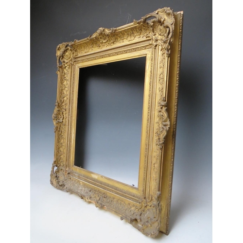 34 - A LATE 18TH / EARLY 19TH CENTURY DECORATIVE GOLD SWEPT FRAME, with integral slip, frame W 11 cm, reb... 