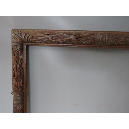 35 - A 19TH CENTURY OAK FRAME WITH CARVED LEAF DESIGN, frame W 7 cm, rebate 50 x 65 cm