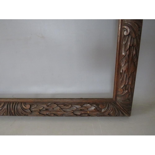 35 - A 19TH CENTURY OAK FRAME WITH CARVED LEAF DESIGN, frame W 7 cm, rebate 50 x 65 cm