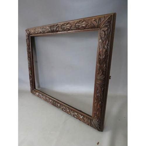 35 - A 19TH CENTURY OAK FRAME WITH CARVED LEAF DESIGN, frame W 7 cm, rebate 50 x 65 cm